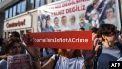Журналісти біля офісу опозиційної газети «Джумхурієт» (Cumhuriyet) у Стамбулі тримають банер із написом «Журналістика – це не злочин», Туреччина, 24 липня 2017 року