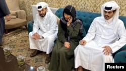 Faye Hall speaks on the phone at the Qatari Embassy in Kabul following her release.