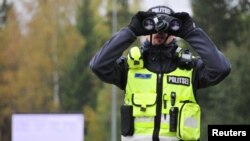 An Estonian police officer looks on near Rapla