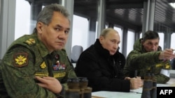 Президент России Владимир Путин и министр обороны Сергей Шойгу наблюдают за военными учениями