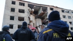 Ukrainian rescuers work at the site of a heavily damaged building following an air attack in Zaporizhzhya on October 30.