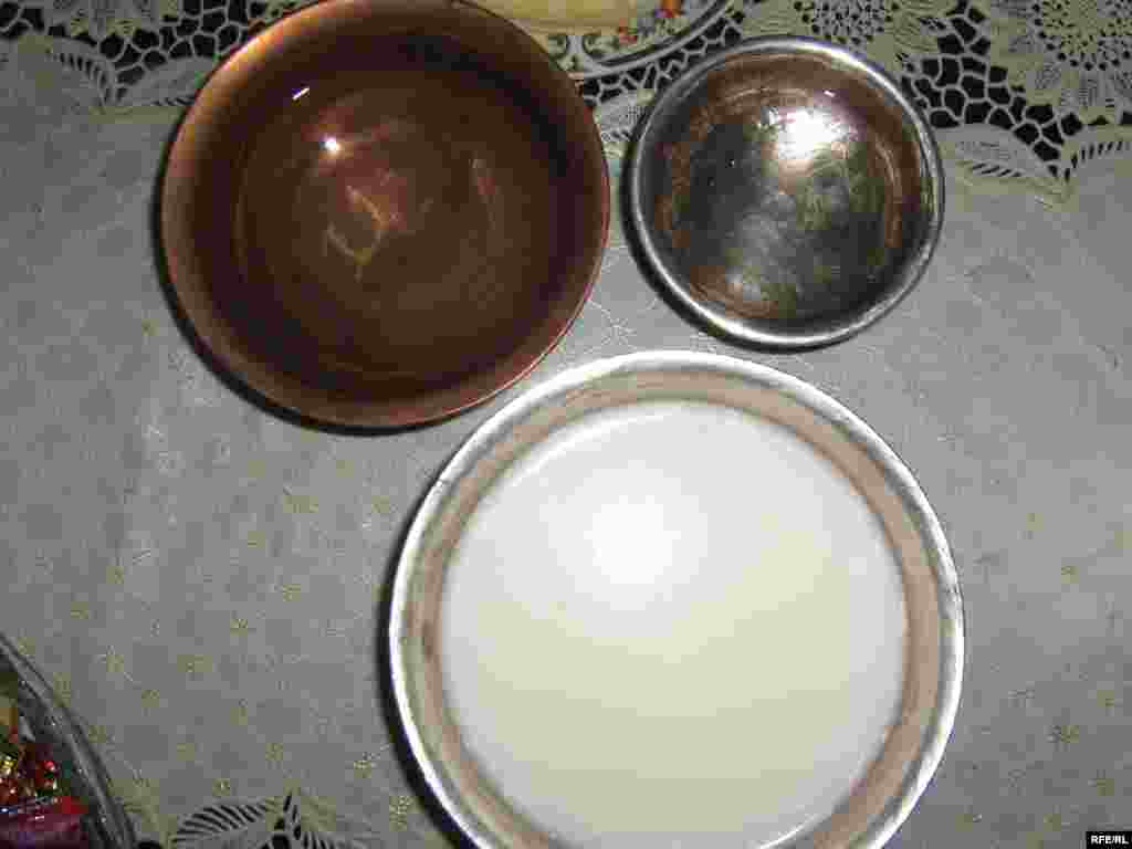 Bowls of vodka, kumiss, and khimiin arkhi, or "milk vodka." - The start of a great evening: Russian vodka; kumiss, the sour, mildly alcoholic drink made from fermented mare's milk, and khimiin arkhi, a mellow, vodka-like drink distilled from milk. Khimiin arkhi is light but potent: Russians living in communist Mongolia called it "khitraya vodka," or "tricky vodka," for its tendency to sneak up on you. Mongolians will often serve alcoholic drinks from a single copper bowl, passed around the table -- a strategy that allows guests to discreetly down as little or as much as they need.