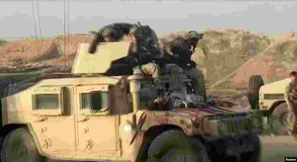 A Humvee with the body of a dead Taliban fighter on its hood on July 7 after fighting around the northern city of Kunduz. 