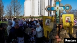 Believers attend a ceremony of blessing Easter cakes and traditional food baskets after the Easter service in front of the St. Andrews Church in the town of Bucha, Kyiv region, Ukraine, on April 20.