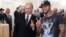Russian Prime Minister Vladimir Putin (left) poses for a photo with rapper Timati during a meeting with his campaign activists in Moscow in March 2012.