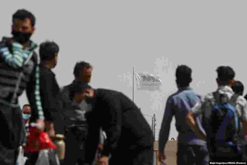The Taliban&#39;s white and black flag flies above the Dowqarun border crossing with Iran on August 29.&nbsp;