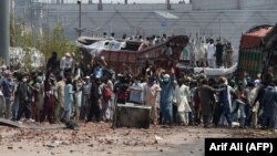 Supporters of Tehrik-e Labaik Pakistan (TLP) block a street in protest after their leader was detained following his calls for the expulsion of the French ambassador, in Lahore on April 18.