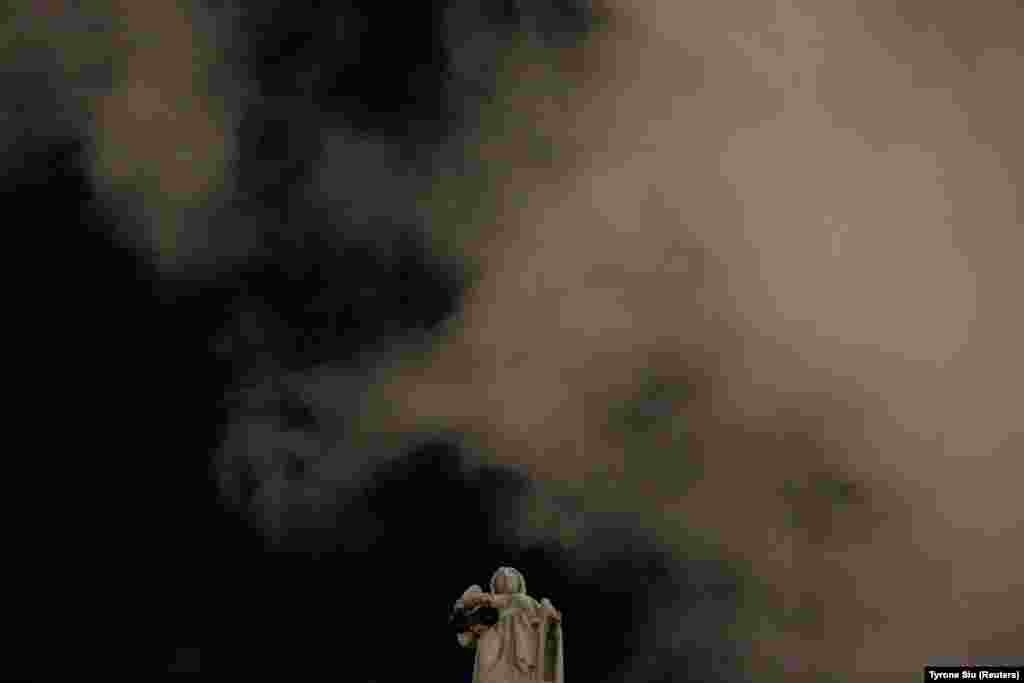 Дим над постаментом Феміди біля Суду останньої інстанції у Гонконгу під час мовчазного протесту