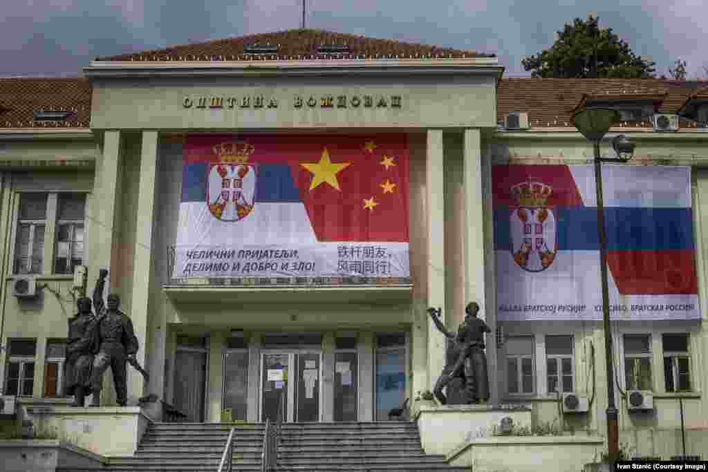 A banner linking Serbian and Chinese flags, and Serbian and Russian ones, on a municipal building in southern Belgrade on April 13. The Cyrillic script on the left says: “Iron Friends, Together In Good And Evil!" and on the right: “Thank You Brother Russia!”        