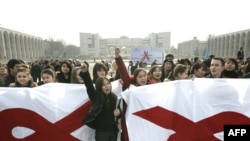 Kyrgyz university students hold banners with red ribbons, symbolizing AIDS awareness, in Bishkek. UN studies reveal that 70 percent of young people in Kyrgyzstan have little or no knowledge of HIV.