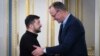 Ukrainian President Volodymyr Zelenskiy (left) and German Christian Democratic Party (CDU) Chairman Friedrich Merz shake hands during their meeting in Kyiv on December 9.