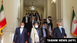 Iranian Foreign Minister Mohammad Javad Zarif (right) met with the Taliban's Mullah Abdul Ghani Baradar (center) in Tehran on January 31.