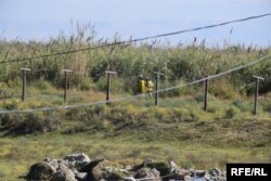 A view from a house in the Farkhor district of a border patrol along no-man's land and into Afghanistan.