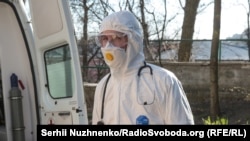 Медичний працівник в спецкостюмі біля інфекційного відділення Олександрівської клінічної лікарні, Київ, 25 березня 2020 року