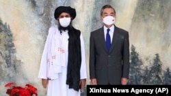 Taliban co-founder Mullah Abdul Ghani Baradar (left) and Chinese Foreign Minister Wang Yi at a meeting in Tianjin earlier this year.