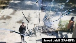 A broken glass pane on Kabul's university campus a day after an attack at the Kabul University.