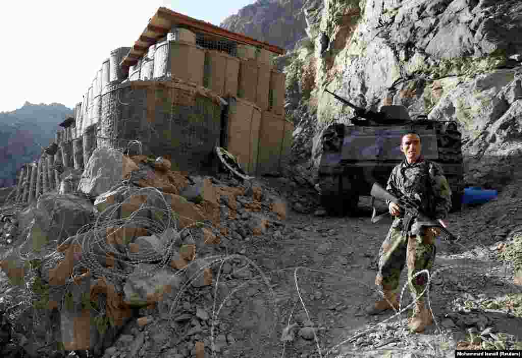 An Afghan National Army soldier stands guard at an isolated checkpoint on the highway between Jalalabad and Kabul on July 8. 