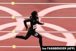 Afghanistan's Kimia Yousofi competes in the women's 100m heats during the Tokyo 2020 Olympic Games at the Olympic Stadium in Tokyo on July 30.