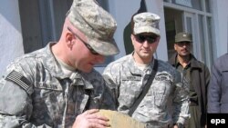 U.S. soldiers inspect opium seized at a border post near Herat, Afghanistan.