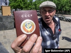 Чоловік демонструє паспорт, на обкладинці якого напис СРСР і колишній радянський герб. Луганськ, 10 травня 2014 року