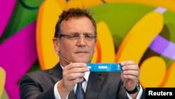 FIFA Secretary-General Jerome Valcke holds the slip showing "Russia" during the draw for the 2014 World Cup in Sao Joao da Mata, Brazil, in December 2013.