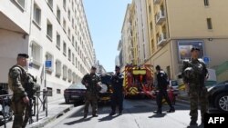 French soldiers, policemen and firefighter vehicles are seen during an antiterror operation in Marseille on April 18.