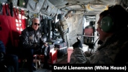 Vice President Joe Biden talks with General David Petraeus, commander of the International Security Assistance Force and U.S. Forces in Afghanistan, aboard a Chinook helicopter over Kabul in 2011.