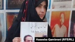 Haseeba Qambrani holds the photo of her disappeared brother Hassan Qambrani at a sit-in protest in Quetta, Balochistan.
