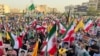 Protestors carry Iranian flags and posters of Supreme Leader Ayatollah Ali Khamenei while chanting anti-US and Israel slogans in Tehran on June 24