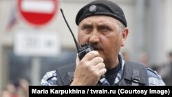 Колишній командир спецпідрозділу «Беркут» Сергій Кусюк у формі ОМОНу на мітингу в Москві, куди він втік від кримінального переслідування за злочини проти Майдану