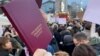 SERBIA - BELGRADE - STUDENTS PROTESTING - HOLDING STUDENT'S TRANSCRIPT