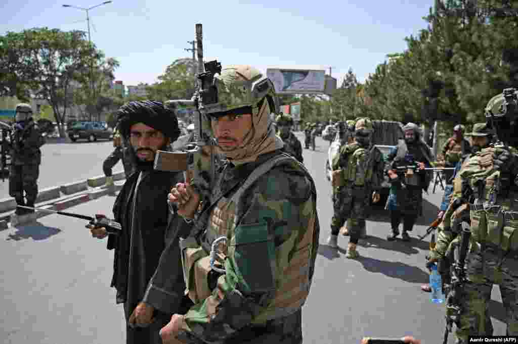 Taliban fighters wearing modern ballistic helmets and carrying U.S.-made weapons at a checkpoint in Kabul on August 29.  