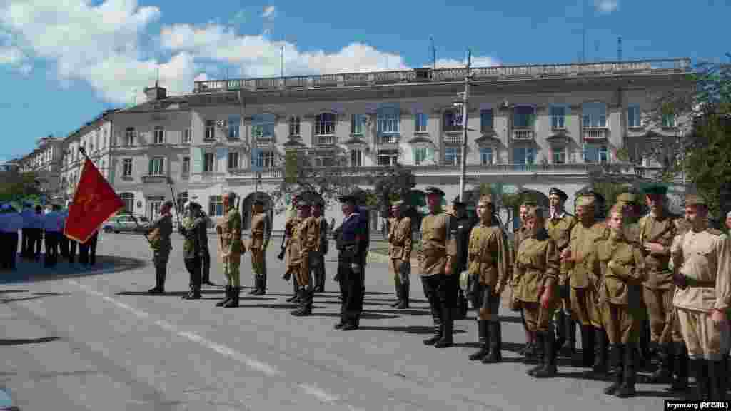 Возле памятников Екатерине Второй, адмиралу Нахимову и Вечного огня участники шествия преклоняли знамена 