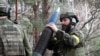 Ukrainian forces prepare to fire artillery rounds near Kupyansk.