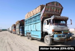 Trucks carrying goods destined to Afghanistan wait for clearance on the Pakistani side of the border at Chaman on April 15.