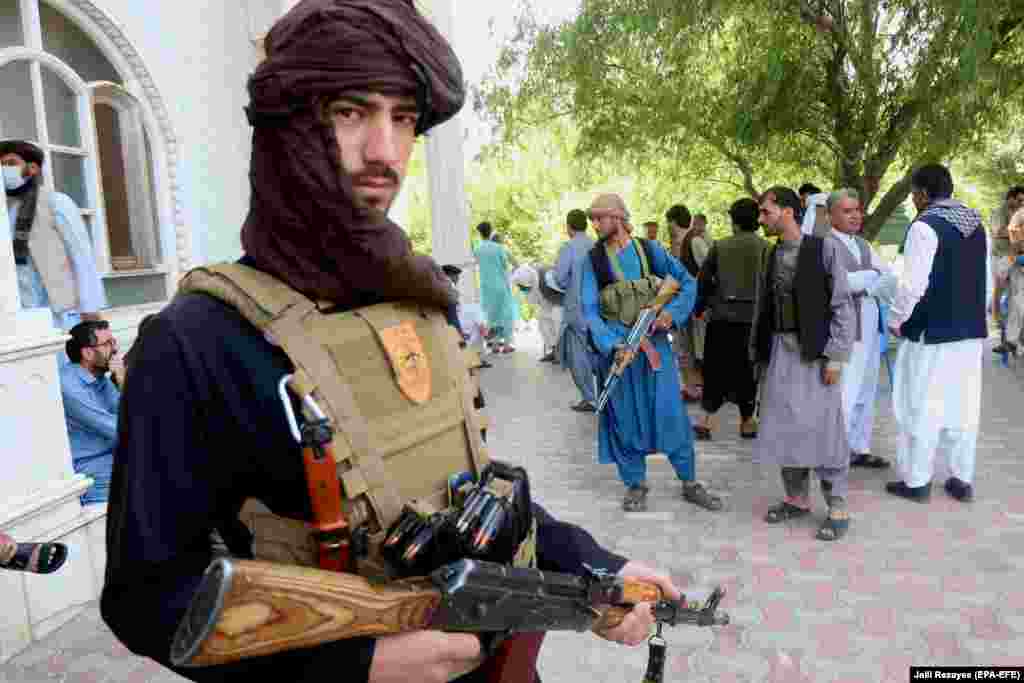 Armed supporters of former mujahedin commander Ismail Khan guard his residence on July 9. Khan and his followers have vowed to fight alongside Afghan security forces against the Taliban as the militants advance into the western Herat Province. 