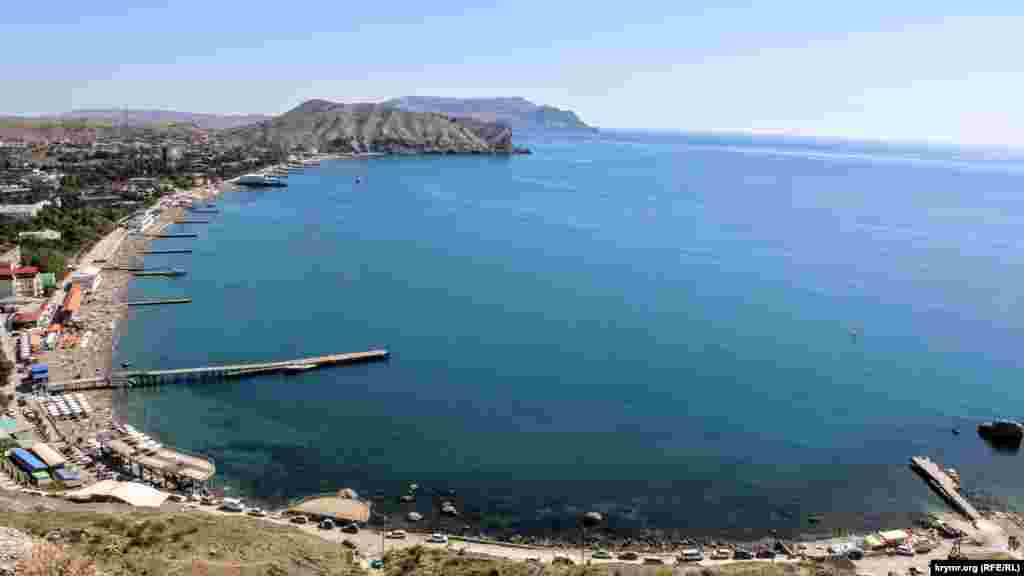 Вид на побережье Судака сверху. На пляжах, расположенных вдоль набережной, немало отдыхающих