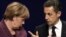 French President Nicolas Sarkozy (right) and German Chancellor Angela Merkel following crisis talks with Greek Prime Minister George Papandreou in Cannes.