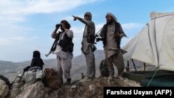 Afghan militia fighters keep watch for Taliban insurgents at an outpost in Afghanistan's Balkh Province.