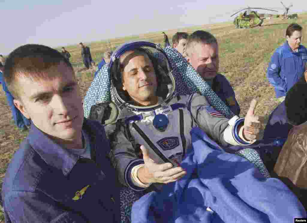 Acaba soaks up the sun shortly after he is removed from the Soyuz capsule. "It's good to be home," he said.