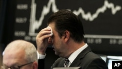 A market analyst at the German stock exchange in Frankfurt on August 5