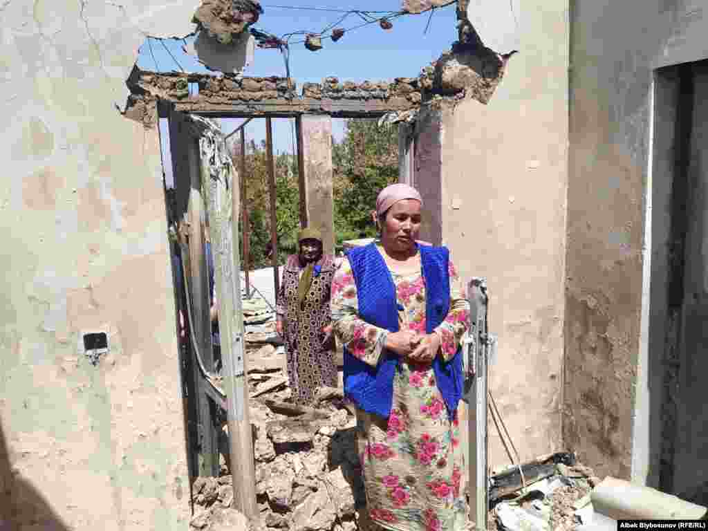 A woman stands in front of her destroyed home in the Kyrgyz village of Maksat. According to Bishkek, 78 private homes were destroyed in Kyrgyzstan's southwestern region of Batken.