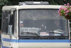 Заручників видно крізь лобове скло автобуса, пошкоджене пострілами зброї