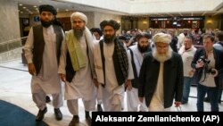 Mullah Abdul Ghani Baradar (third from left), the Taliban's top political leader, arrives with other members of a Taliban delegation for talks in Moscow on May 28, 2019.