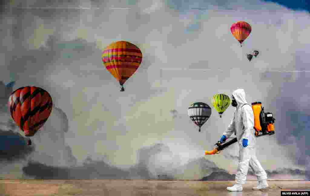 Працівник в захисному спорядженні дезінфікує торгівельний центр в якості профілактичного заходу проти коронавірусу в Кашіас-ду-Сул, Бразилія. (AFP/Silvio Avila)&nbsp; &nbsp;