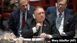 U.S. Secretary of State Mike Pompeo adjusts his tie during a UN Security Council meeting on Iran's compliance with the 2015 nuclear agreement at United Nations headquarters in New York on December 12.