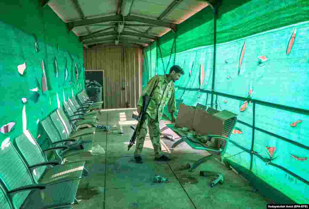 An Afghan soldier looks through items left by the U.S. military at Bagram Airfield on July 5. 