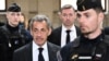 (FILES) France's former president Nicolas Sarkozy (C-L) arrives for the verdict in his appeal trial in the so-called Bygmalion case, at the courthouse, in Paris, on February 14, 2024.