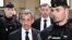 (FILES) France's former president Nicolas Sarkozy (C-L) arrives for the verdict in his appeal trial in the so-called Bygmalion case, at the courthouse, in Paris, on February 14, 2024.