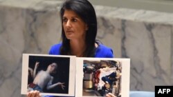 U.S. Ambassador to the UN Nikki Haley holds photos of victims of the Syrian gas attack as she speaks as the UN Security Council meets in an emergency session in New York last week.